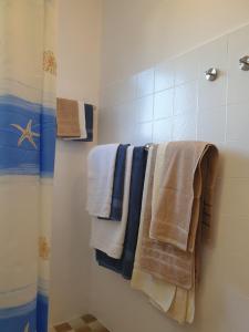 a bathroom with towels hanging on a shower at Orebic BnB in Orebić +46 photos
