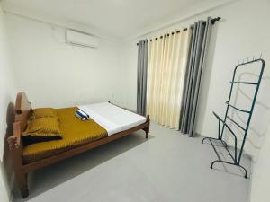 a bedroom with a bed and a ladder in it at Lumora - Midigama in Midigama East