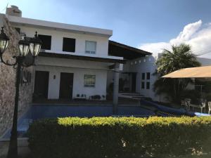 a house with a pool in front of it at La casa flores in Atlixco