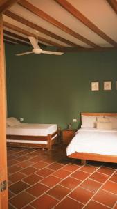 a bedroom with two beds and a ceiling fan at Hotel Jardin Boutique rodadero in Santa Marta +41 photos
