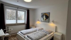 a bedroom with a bed and a window at ask rooms Privatzimmer in Kassel in Kassel