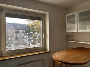 a kitchen with a window and a wooden table at ask rooms Privatzimmer in Kassel in Kassel