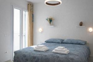 a bedroom with a bed with towels on it at Residenza Sa Olia in Budoni