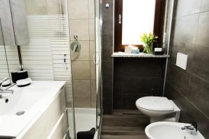 a bathroom with a toilet and a sink and a shower at B&B Mary in Alba +9 photos