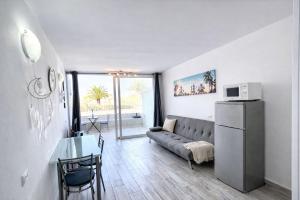 a living room with a couch and a table at Oasis Costa del Silencio - Large Pool & Relax in Costa Del Silencio