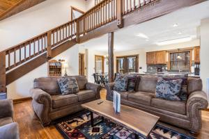 a living room with two couches and a table at Cozy 'Rustic River Lodge' Near SDC with Pools! in Branson