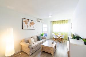 a living room with a couch and a table at Avenida Principal muy cerca de la playa - By Aloha Palma in Águilas +21 photos