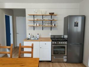 a kitchen with a stainless steel refrigerator and a sink at Lakepoint Cottage Resort in Killaloe Station +64 photos
