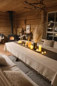a table with candles and food on it in a room at Privatus namelis gamtoje greta Trakų in Daugirdiškės
