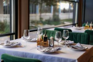 a table with wine glasses and napkins on it at Hotel Blu Mare Shengjin in Shëngjin