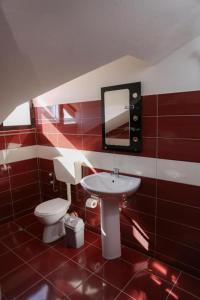 a bathroom with a toilet and a sink and a mirror at Hotel Blu Mare Shengjin in Shëngjin +45 photos