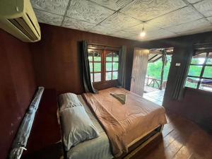a bedroom with a bed in a room at Chaloklum Belvedere B6 in Ko Phangan