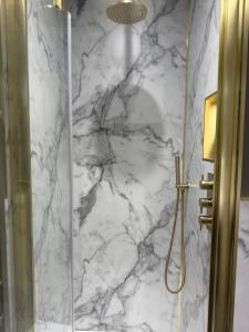 a bathroom with a marble shower with a glass door at Shemara rooms in Keswick +63 photos