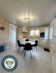 a kitchen and dining room with a table and chairs at Gite OWEN in Bourbourg +9 photos