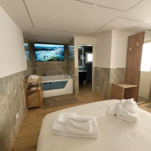 a bathroom with a tub and a bed with towels at TOP1 Templum Luxuriae in Reggio di Calabria +148 photos