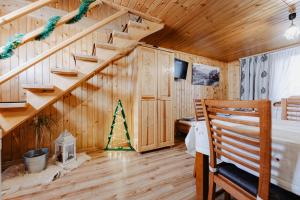 a bedroom with wooden walls and stairs in a house at Pokoje u Gronicki in Bukowina Tatrzańska