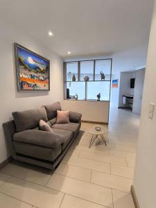 a living room with a couch and a table at ONE Luxury Suite Super King Bed & Volcano View in Quito