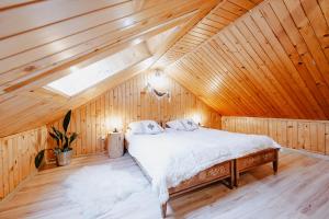 a bedroom with a bed in a wooden attic at Pokoje u Gronicki in Bukowina Tatrzańska