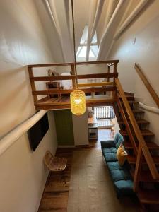 a living room with a staircase and a couch at Casa Terra Cusco in Cusco