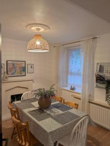 a dining room with a table and a window at Ivy Townhouse Derry in Derry Londonderry +32 photos