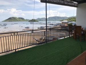 a balcony with a view of the beach and water at Homestay Jifiqa komodo in Komodo