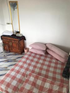 a bedroom with a bed with a mirror and a dresser at Homestay Jifiqa komodo in Komodo