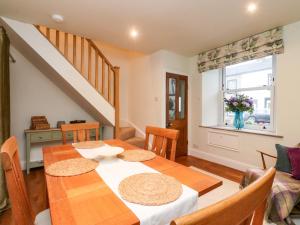 a dining room with a table and a window at Cobble Cottage in Clitheroe