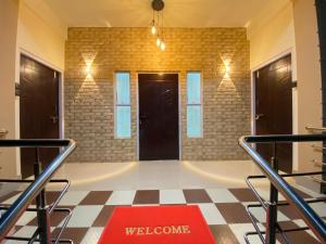 a room with two doors and a welcome mat on the floor at Miro Homestay in Tura