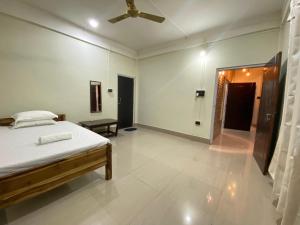 a bedroom with a bed and a ceiling fan at Miro Homestay in Tura