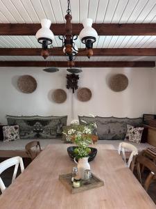 a dining room with a wooden table and a ceiling at Chalupa Svratouch in Svratouch