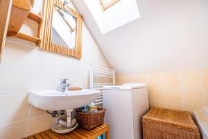 a bathroom with a sink and a refrigerator at Chalupa Svratouch in Svratouch +48 photos