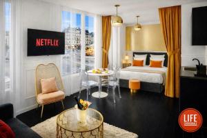 a hotel room with a bed and a table at LIFE CATHEDRALE City-Center Place Gutenberg in Strasbourg