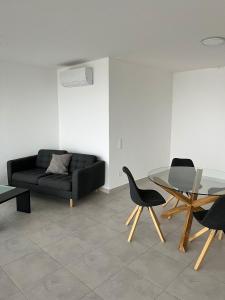 a living room with a black couch and a glass table at Via privata in Lugano +7 photos