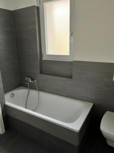 a bathroom with a bath tub and a toilet at Via privata in Lugano