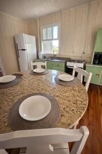 a kitchen with a table with plates on it at ROTA DA SERRA casa completa com ar-cond in Orleans +3 photos