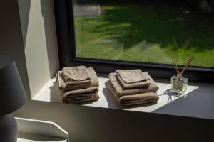 a group of towels sitting on a window sill at La Barzalière in Chimay +137 photos