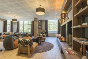a living room with a couch and a fireplace at Résidence Odalys L'Ecrin de Vars in Vars