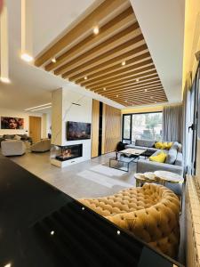 a living room with a couch and a fireplace at La Villa Kfardebian Stone Villa in Fārayyā