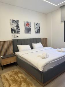 a large bed in a room with posters on the wall at La Villa Kfardebian Stone Villa in Fārayyā +56 photos