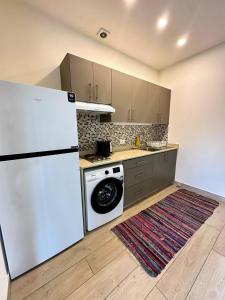 a kitchen with a refrigerator and a washing machine at B-eight in Batroûn