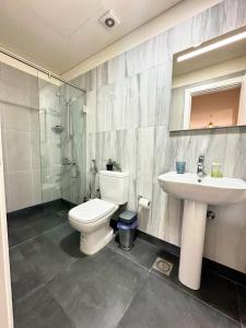 a bathroom with a toilet and a sink and a shower at B-eight in Batroûn