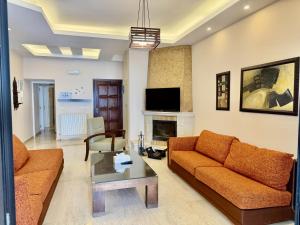 a living room with a couch and a fireplace at Mountain View Ariz in Al Arz