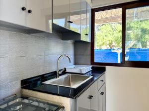 eine Küche mit Spüle und Fenster in der Unterkunft Lemon in Al Madfūn + 27 Fotos