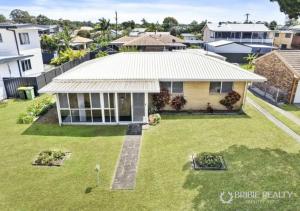 an aerial view of a house with a yard at Eden Cottage in Woorim