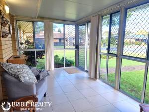 a screened in porch with sliding glass doors at Eden Cottage in Woorim +30 photos