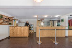 a woman standing at a counter in a room at Résidence Odalys Pra Sainte Marie in Vars +42 photos
