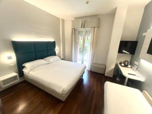 a bedroom with a large white bed and a window at Best Western Cesena Hotel in Cesena +42 photos