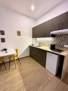 a kitchen with a sink and a table and a counter at B-nine Batroun Central | Studio w/ Parking in Batroûn