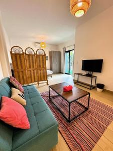 a living room with a couch and a coffee table at B-nine Batroun Central | Studio w/ Parking in Batroûn