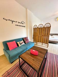 a living room with a blue couch and a table at B-nine Batroun Central | Studio w/ Parking in Batroûn
